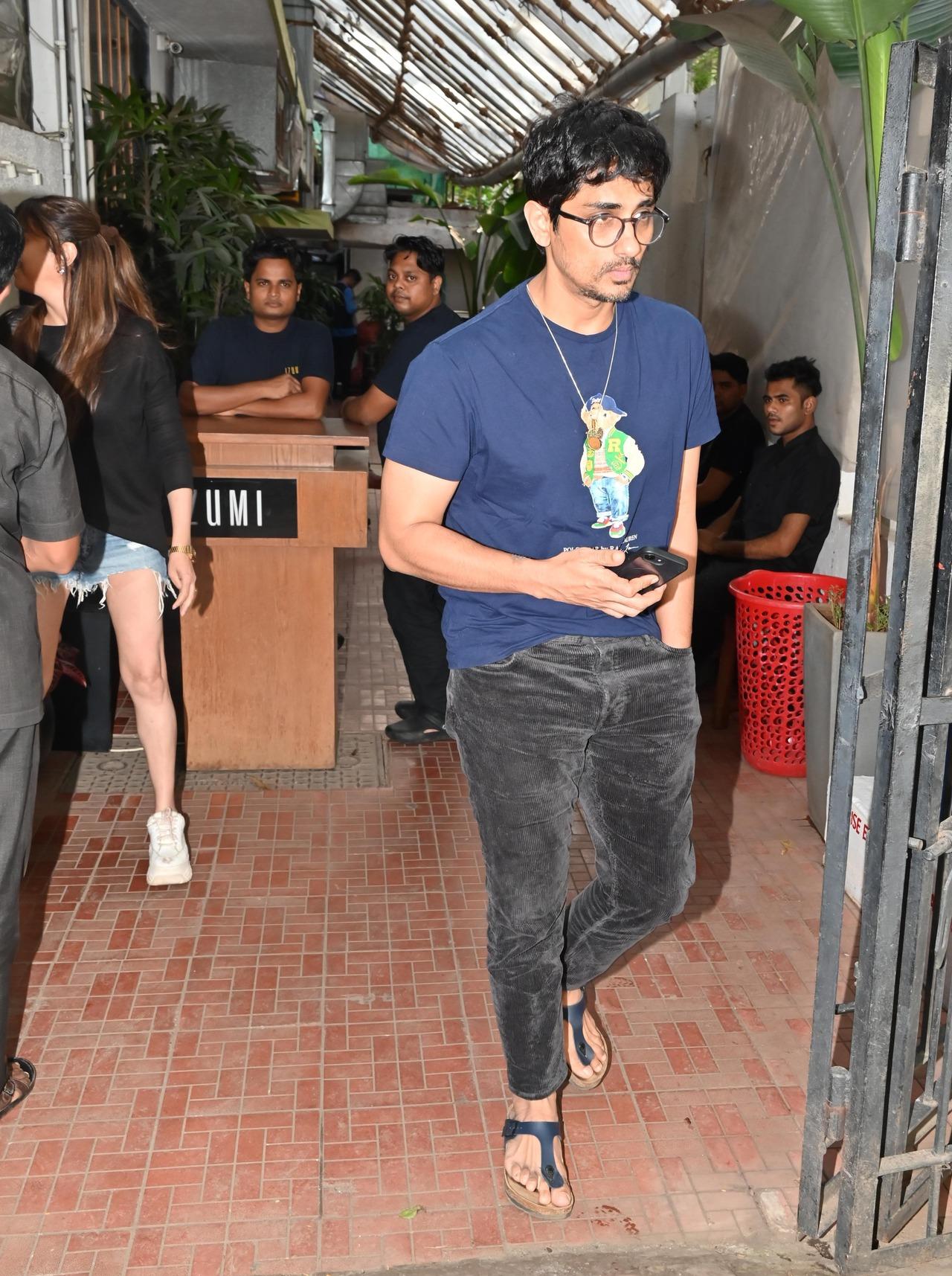 Actor Siddharth was seen at a restaurant with his wife and actress Aditi Rao Hydari. She sported a simple blue graphic tee with ash grey jeans. 